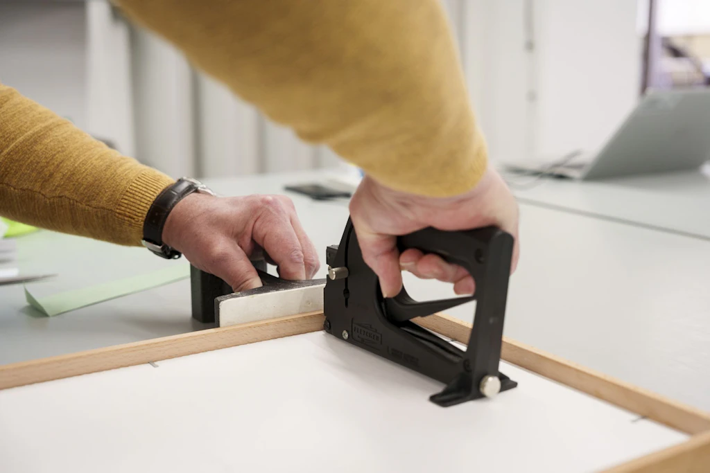A National Library staff member secures the mount using a point driver.