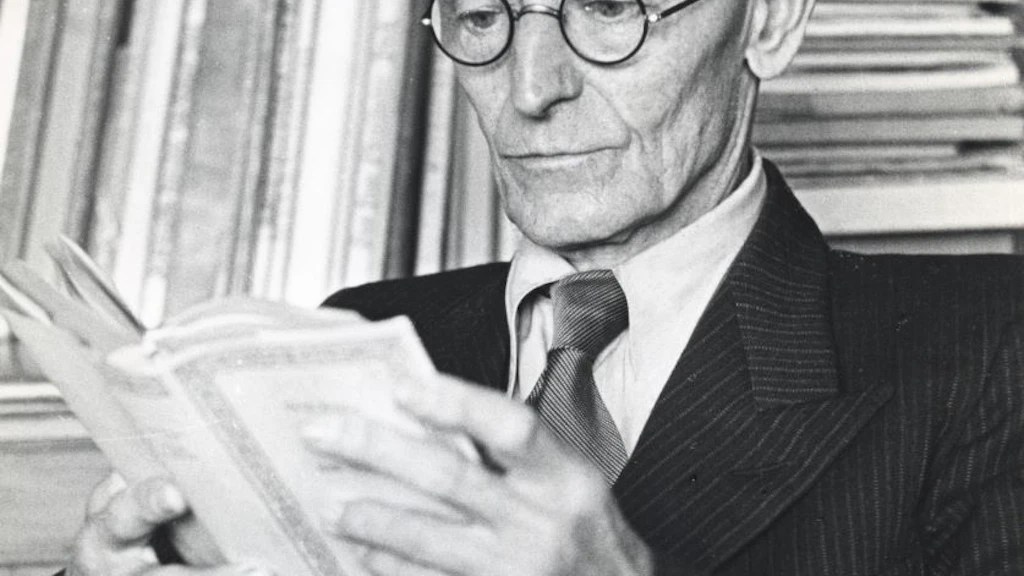 Hermann Hesse in front of a bookshelf, deep in thought and immersed in a book.