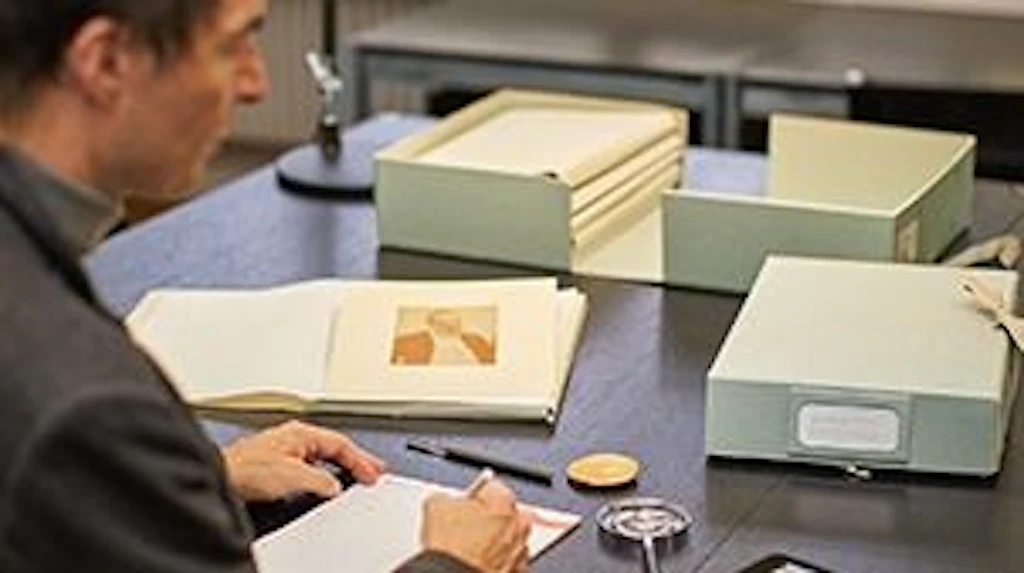 A person checking the archives of the Prints and Drawings Department.