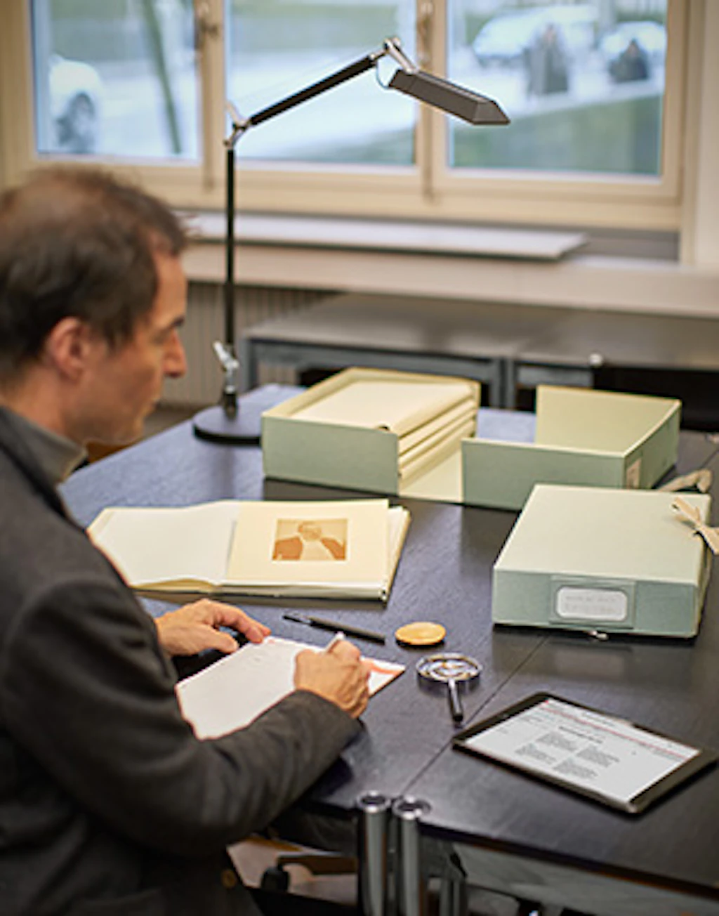 Une personne consulte les archives du Cabinet des estampes.